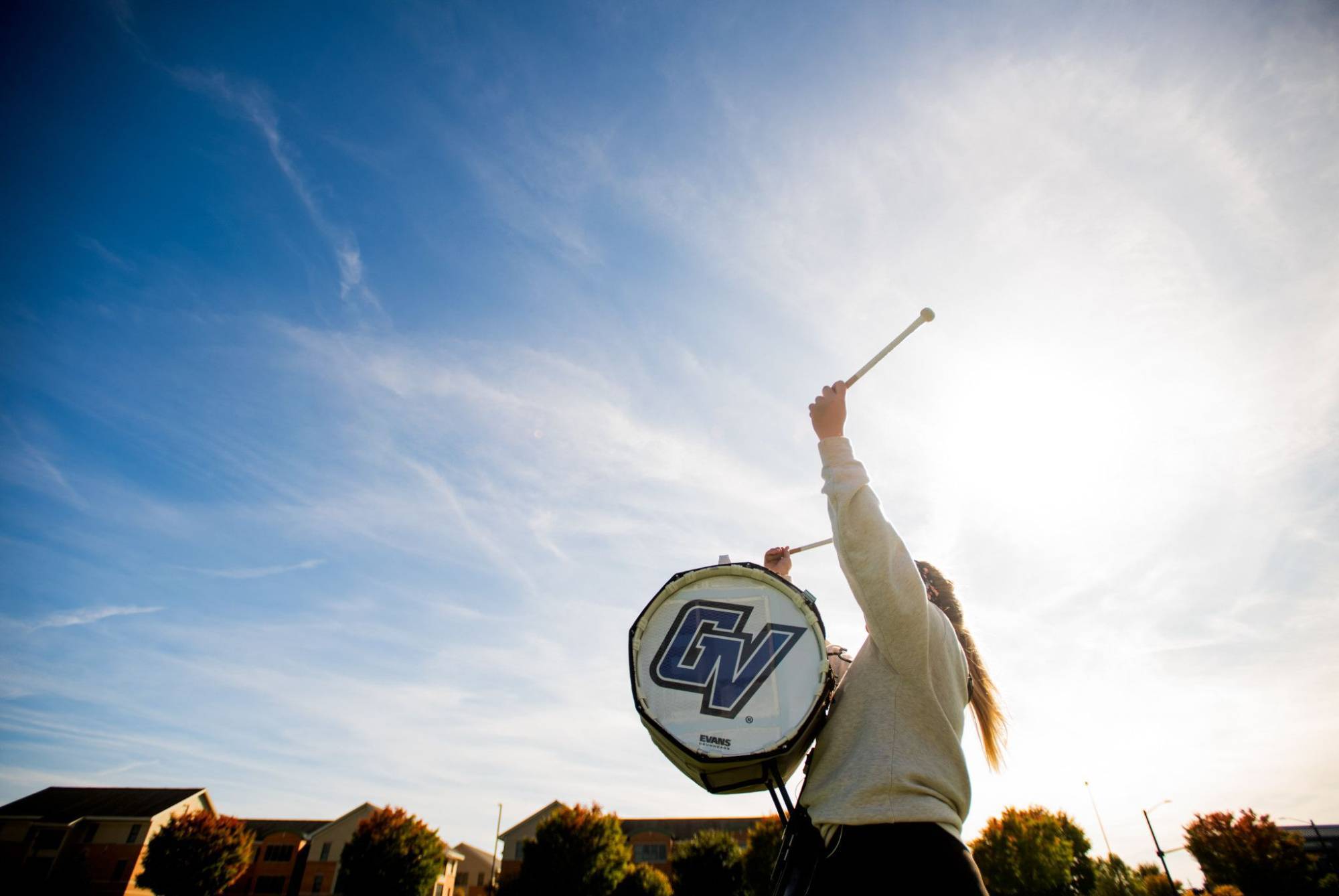 Drum player in the marching band with a GV logo on the drum